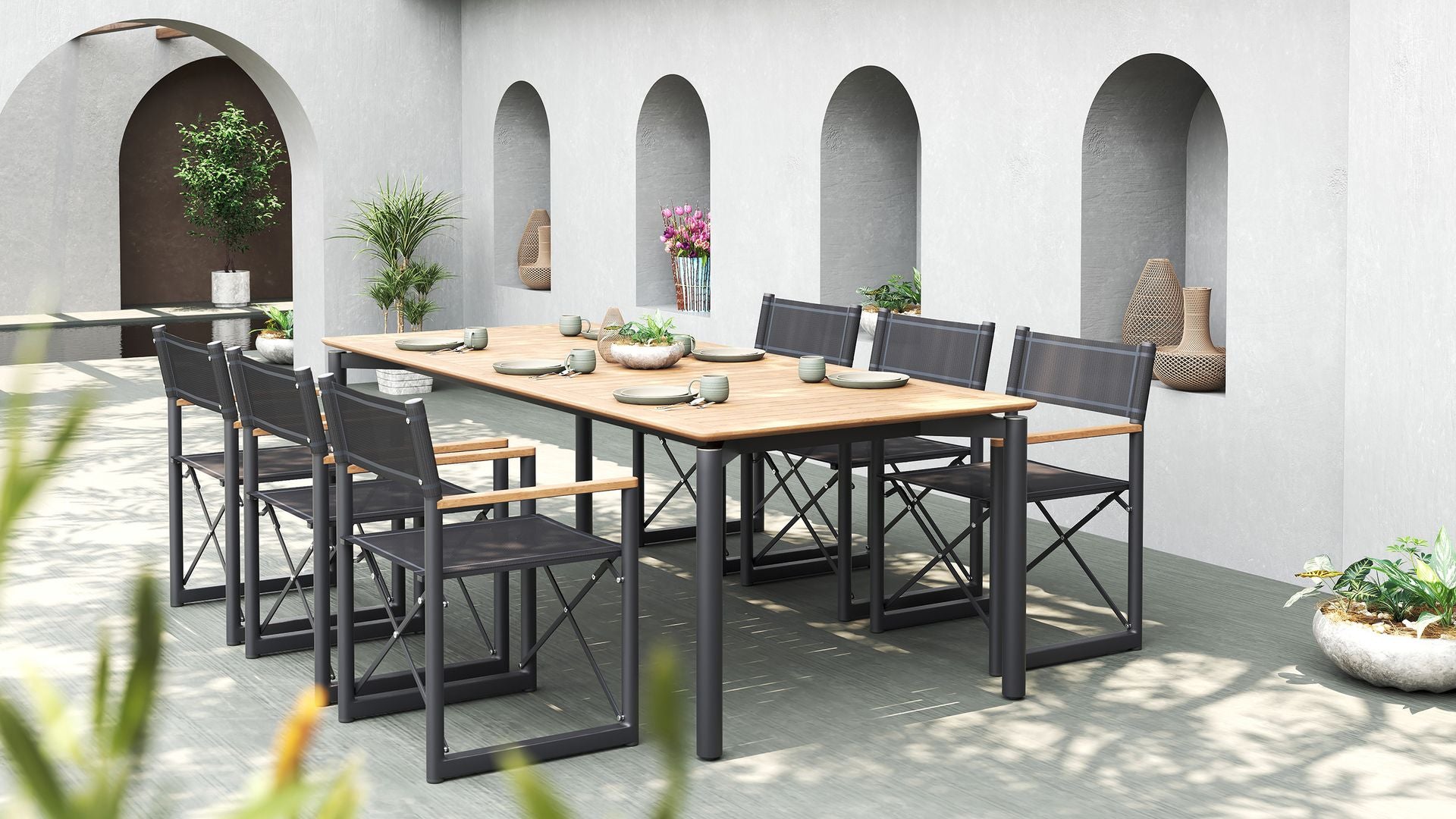 Large outdoor dining set with a teak table and six black Aleta director chairs from Be A Little.