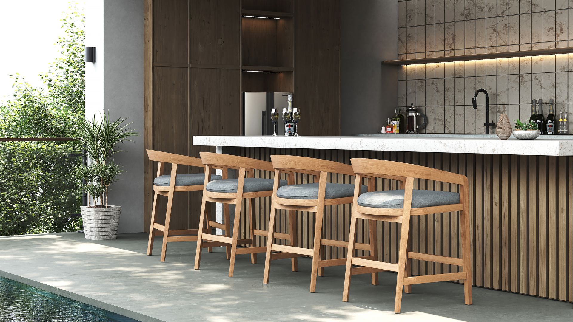 Modern wooden counter stools with grey cushions arranged with an outdoor marble-top bar by the pool.