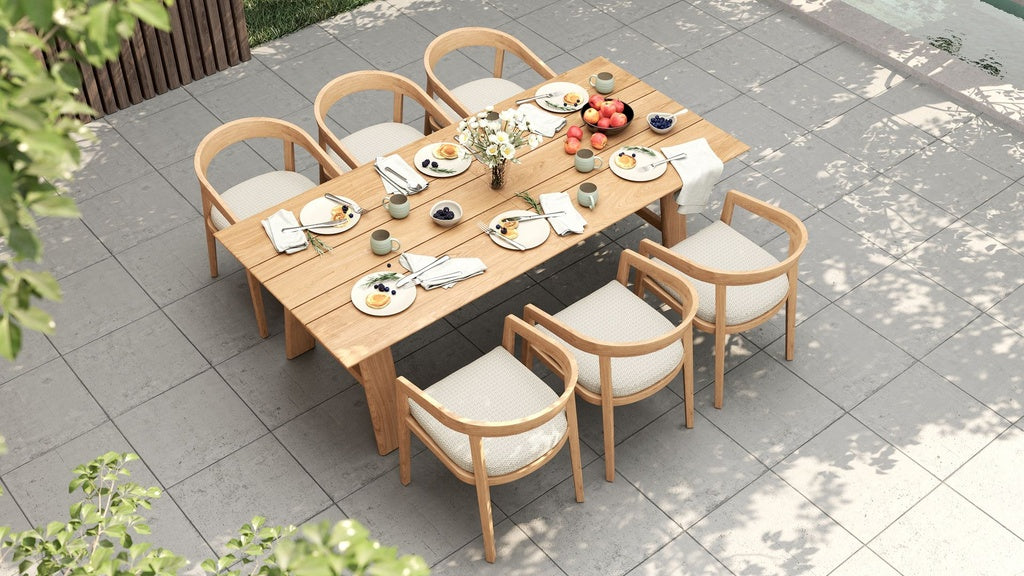 Overhead view of a prepared outdoor dining table with six Vento dining chairs on a tiled patio.