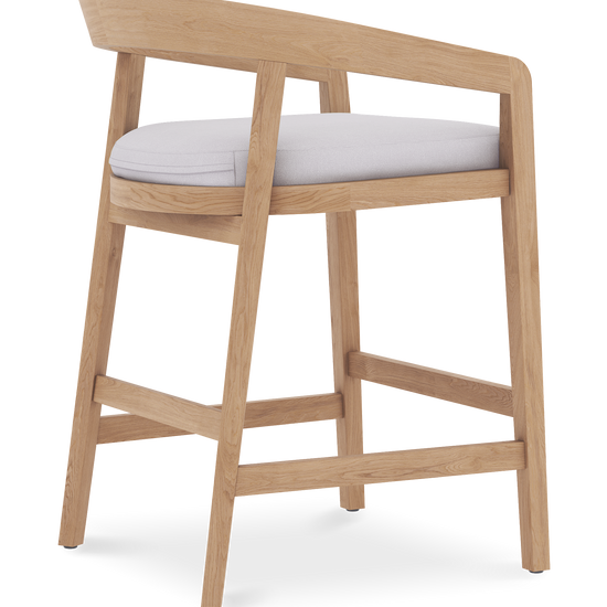 Rear angled view of Vento counter stool with teak wood frame, open back design, & padded white seat.