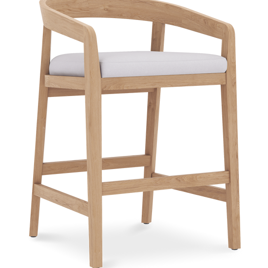 Light oak wooden counter stool with curved backrest and cushioned white seat for a modern kitchen.