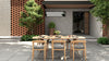 Outdoor dining set with a rectangular table & six Vento dining chairs with gray cushions on a patio.