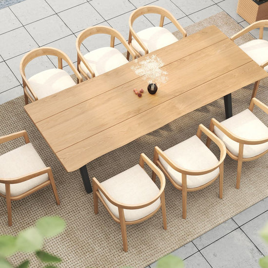 Top-down view of an outdoor dining set with a long table and eight curved-back wooden dining chairs.