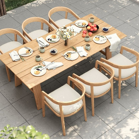 Overhead view of a prepared outdoor dining table with six Vento dining chairs on a tiled patio.