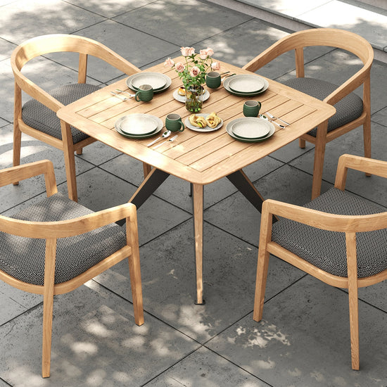 Overhead view of a small square outdoor dining set with a gray pattern on the outdoor dining chairs.