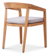 Three-quarter view of a modern wooden dining chair with a light-color cushioned seat by Be A Little.